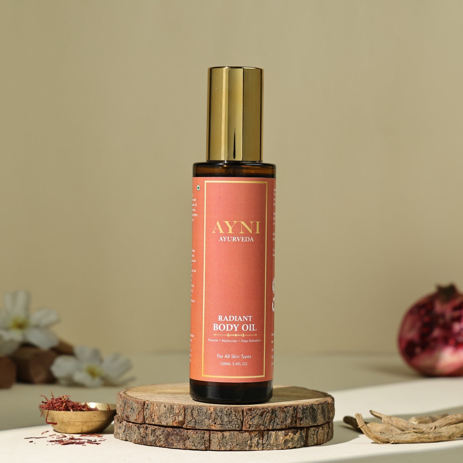 Ayni Ayurveda Radiant Body Oil bottle on a wooden stand with a neutral background