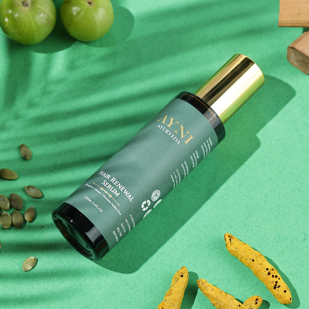 Hair renewal serum bottle on a green background with natural elements