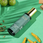 Hair renewal serum bottle on a green background with natural elements