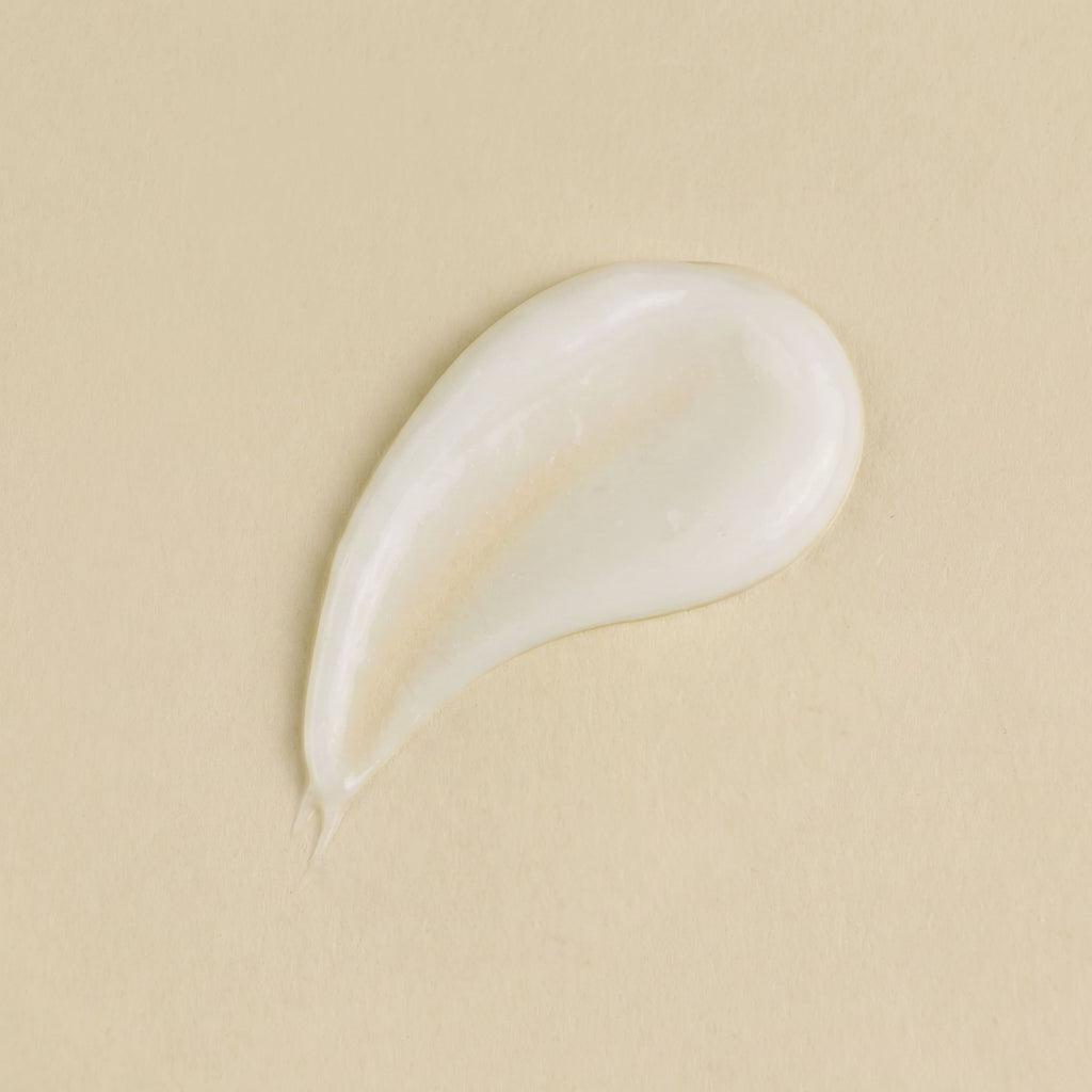 White cream droplet on a beige background