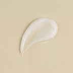 White cream droplet on a beige background
