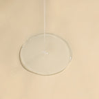 Clear circular object on a beige background