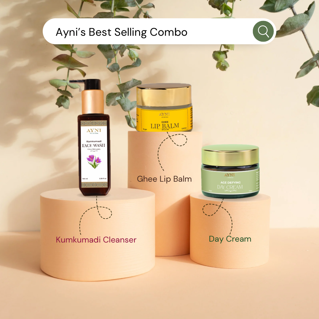 Ayni skincare products including Kumkumadi Cleanser, Ghee Lip Balm, and Day Cream on a beige background with greenery.