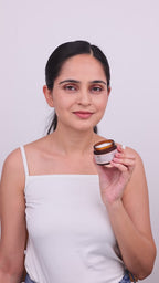A lady showing how to apply night renewal  cream