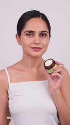 A lady showing how to apply age defying day cream